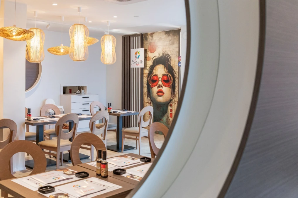 Salle : banquette courbe, fresque murale et suspensions dorées — Asie a tik - Waterloo