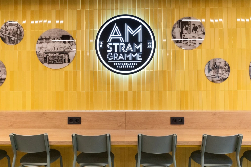 Mur jaune avec logo rétroéclairé et tablette continue — Am Stram Gramme